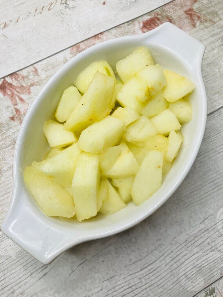 Par-cooked apple chunks in a white dish