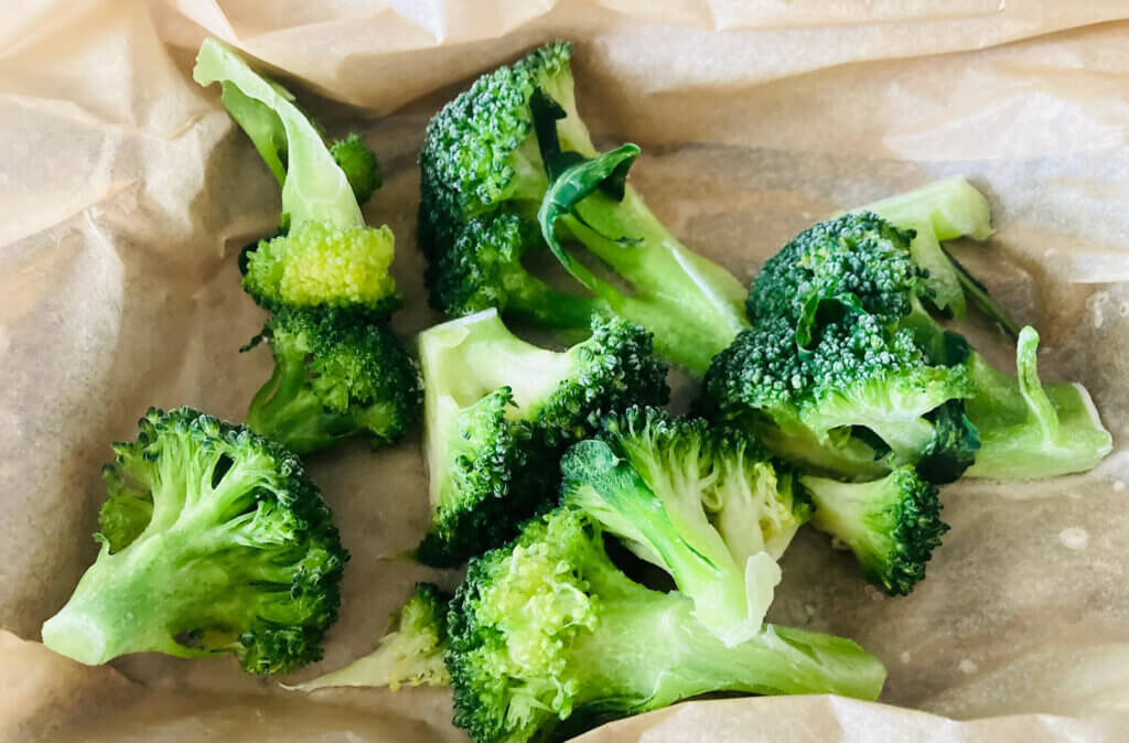 Frozen broccoli florets which are hard and slightly icy